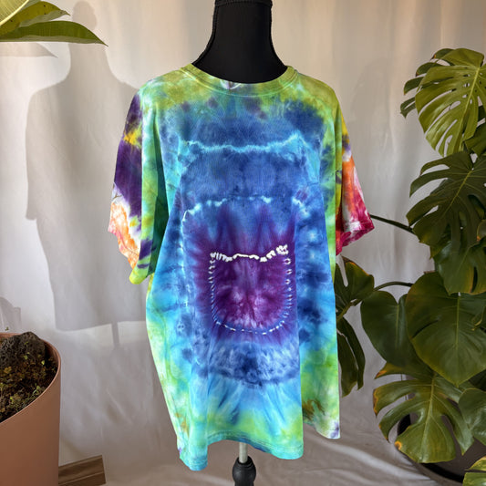Tie-dye shirt on a mannequin with plants in the background