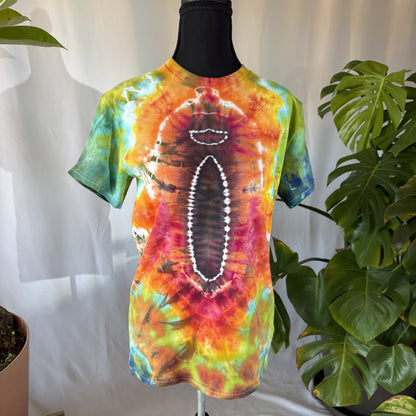 Colorful tie-dye t-shirt on a mannequin with plants in the background