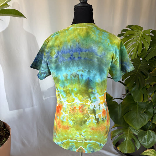 Tie-dye t-shirt on a mannequin with a white background and plants around